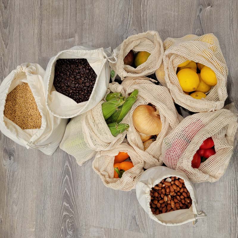 Collection of Muslin and Mesh produce bags filled with produce, beans, nuts, and grains.