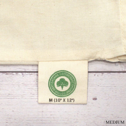 close up of medium muslin bag tag showing dimensions of 10" x 12"