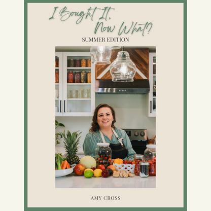 i-bought-it-now-what-summer-edition-book-cover-amy-cross-leaning-on-her-kitchen-counter-with-a-beautiful-spread-of-fresh-fruit-and-a-variety-of-fresh-fruits-in-mason-jars