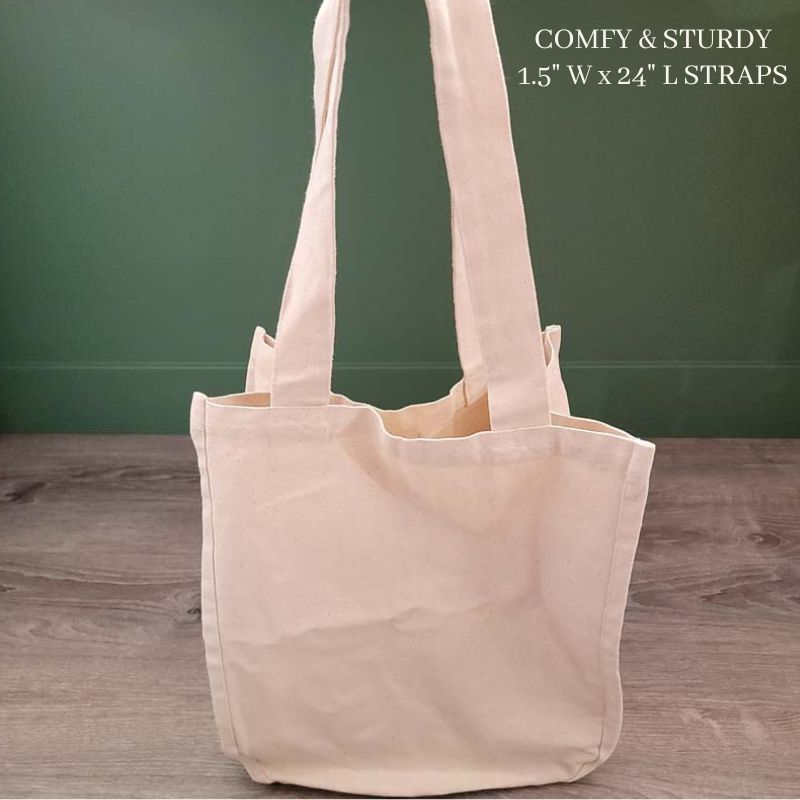 organic cotton canvas market bag sitting on the floor against a green wall showing length of strap