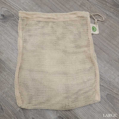 large mesh produce bag laying flat on a wooden surface