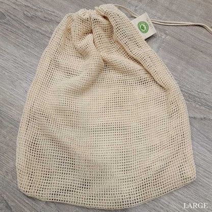 large mesh produce bag laying flat wooden surface
