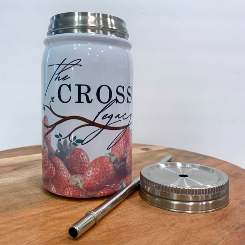 the-cross-legacy-stainless-steel-tumbler-with-lid-and-straw-sitting-on-a-wooden-table-with-white-background